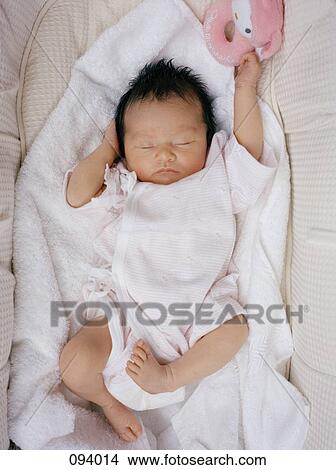 Picture - Baby sleeping in crib. Fotosearch
