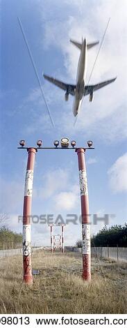 Airplane flying over red and white markers, Tegel airport, Berlin, Germany View Large Photo Image Stock Image - Airplane flying over red and white markers, Tegel airport, Berlin, Germany. Fotosearch