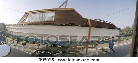 Stock Photography - Boat being transported on highway. Fotosearch