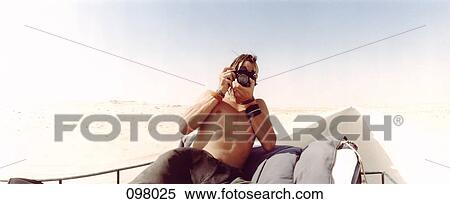 Man taking picture on top of vehicle, Sahara desert, Egypt View Large Photo Image Stock Photography - Man taking picture on top of vehicle, Sahara desert, Egypt . Fotosearch
