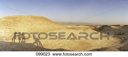 Stock Image - Group of silhouettes on mountain side, Dead Sea canyon, Israel. Fotosearch