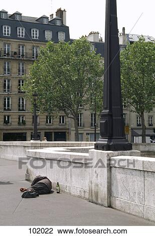 Homeless man lying down on bridge, Paris, France View Large Photo Image Stock Image - Homeless man lying down on bridge, Paris, France. Fotosearch