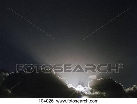 Sunlight breaking through clouds View Large Photo Image Stock Photograph - Sunlight breaking through clouds. Fotosearch