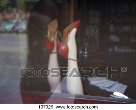 Stock Photography - Mannequin’s legs with red shoes. Fotosearch