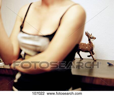 Woman standing in front of a reindeer figure View Large Photo Image Stock Image - Woman standing in front of a reindeer figure. Fotosearch