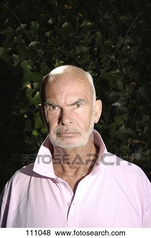 Angry man in pink t-shirt View Large Photo Image Stock Photo - Angry man in pink t-shirt. Fotosearch