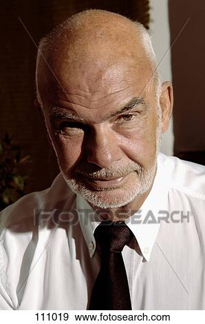 Man in shirt and tie looking at camera View Large Photo Image Stock Photo - Man in shirt and tie looking at camera. Fotosearch