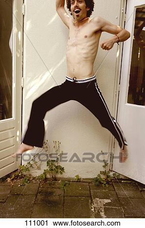 Shirtless man jumping in mid-air View Large Photo Image Stock Image - Shirtless man jumping in mid-air. Fotosearch