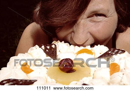 Woman biting into a cake View Large Photo Image Stock Image - Woman biting into a cake. Fotosearch
