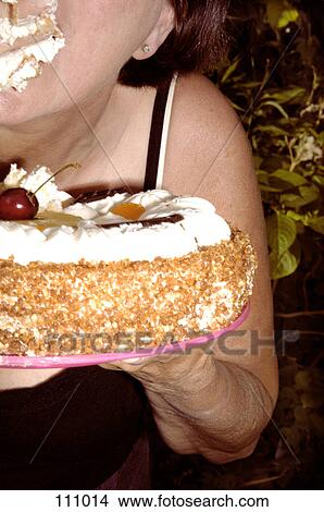 Woman eating cake View Large Photo Image Picture - Woman eating cake. Fotosearch