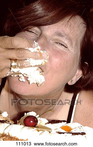Woman eating cake with hand View Large Photo Image Stock Image - Woman eating cake with hand. Fotosearch