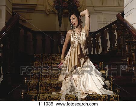 Woman kneeling on stairs in evening gown View Large Photo Image Stock Photograph - Woman kneeling on stairs in evening gown. Fotosearch