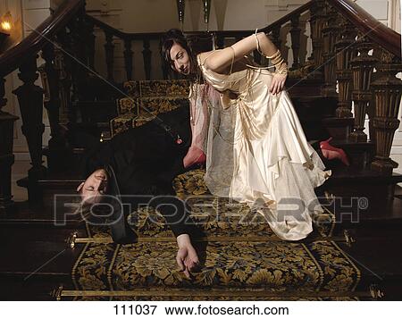 Woman kneeling over man lying on stairs View Large Photo Image Stock Photo - Woman kneeling over man lying on stairs. Fotosearch
