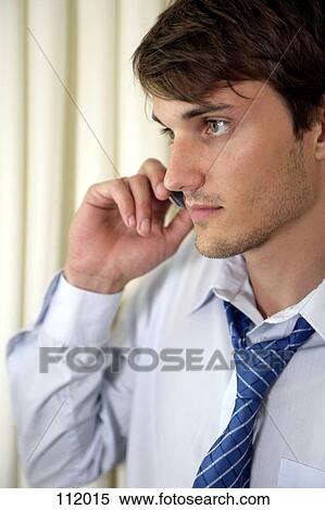 Businessman using cell phone View Large Photo Image Stock Photography - Businessman using cell phone. Fotosearch
