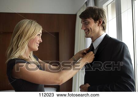 Woman tying man’s necktie View Large Photo Image Stock Image - Woman tying man’s necktie. Fotosearch