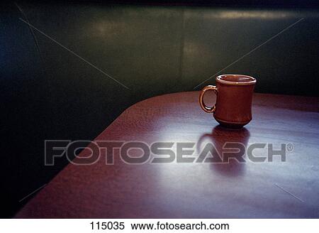 Stock Photography - Ceramic mug on wooden table. Fotosearch