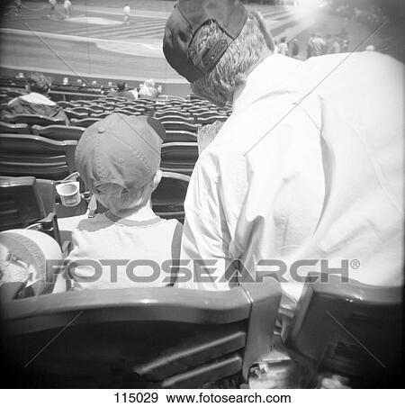 Man and boy watching baseball game View Large Photo Image Stock Photo - Man and boy watching baseball game. Fotosearch