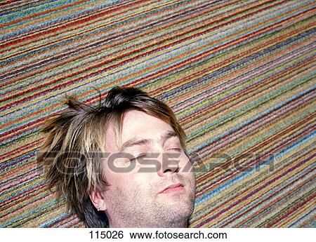Man Sleeping On Multicolored Carpet Stock Photograph 115026