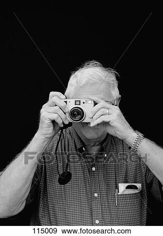 Man taking a picture View Large Photo Image Stock Photo - Man taking a picture. Fotosearch