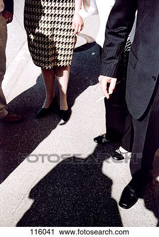 Stock Image - Businesspeople standing together. Fotosearch