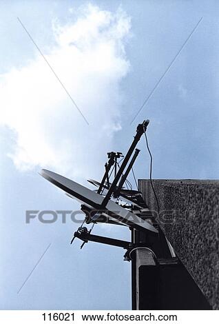 Stock Image - Satellite dishes mounted on building. Fotosearch