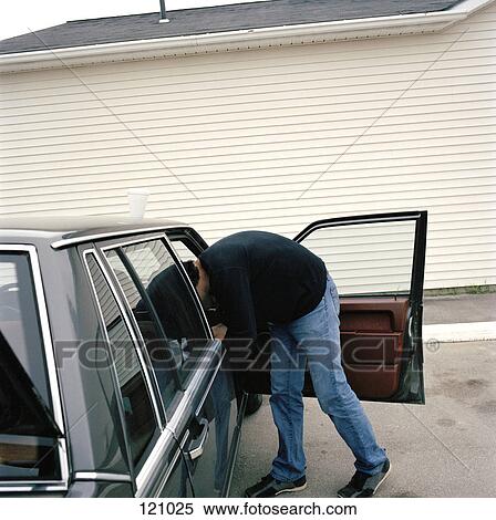Stock Photography - Man leaning into station wagon. Fotosearch