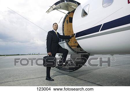 Businessman boarding a private airplane View Large Photo Image Picture - Businessman boarding a private airplane. Fotosearch