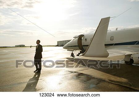 Businessman disembarking from a private airplane View Large Photo Image Picture - Businessman disembarking from a private airplane. Fotosearch