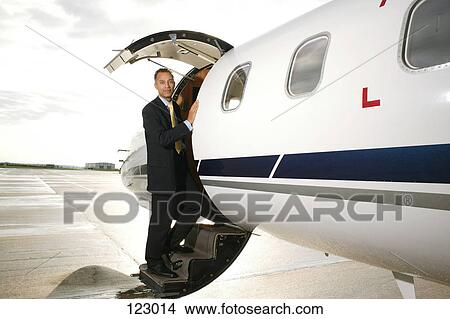 Businessman standing on a private airplane’s steps View Large Photo Image Picture - Businessman standing on a private airplane’s steps. Fotosearch