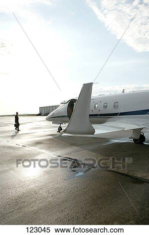 Stock Photography - Businessman walking towards a private airplane. Fotosearch