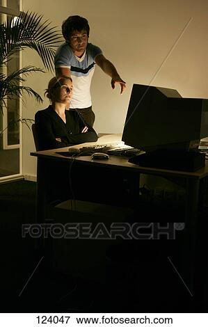Man and woman discussing at an office desk View Large Photo Image Stock Photo - Man and woman discussing at an office desk. Fotosearch