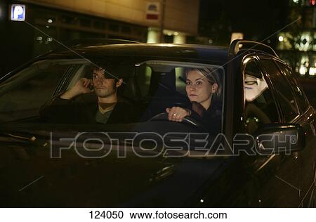 Man on cell phone while woman drives a car View Large Photo Image Stock Image - Man on cell phone while woman drives a car. Fotosearch