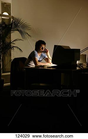 Man on telephone, sitting at office desk View Large Photo Image Stock Photo - Man on telephone, sitting at office desk. Fotosearch
