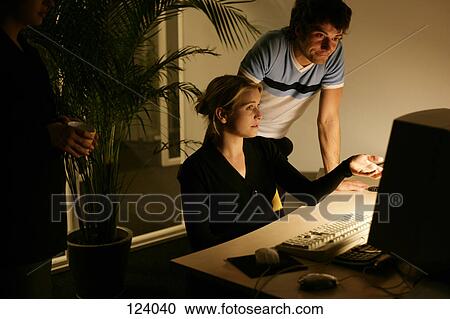 Office workers in front of a computer View Large Photo Image Stock Image - Office workers in front of a computer. Fotosearch