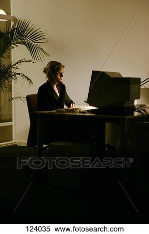 Woman sitting at an office desk View Large Photo Image Stock Photography - Woman sitting at an office desk. Fotosearch