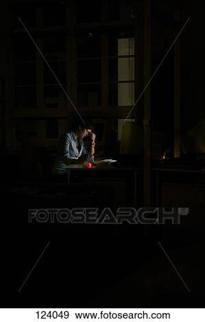 Stock Photo - Woman sitting in the dark at a computer. Fotosearch
