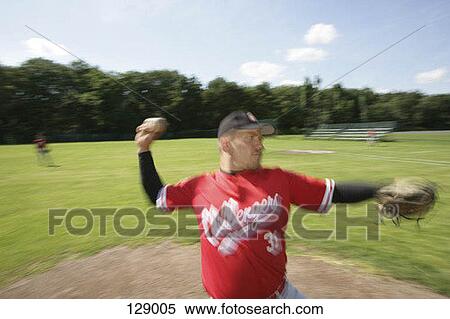 A baseball pitcher throwing a ball View Large Photo Image Stock Photography - A baseball pitcher throwing a ball. Fotosearch