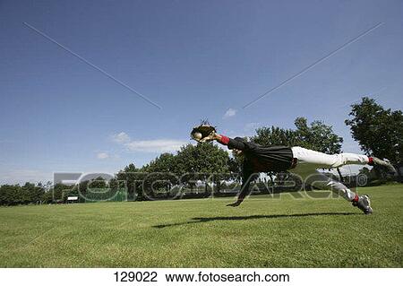 A baseball player catching a ball View Large Photo Image Stock Image - A baseball player catching a ball. Fotosearch