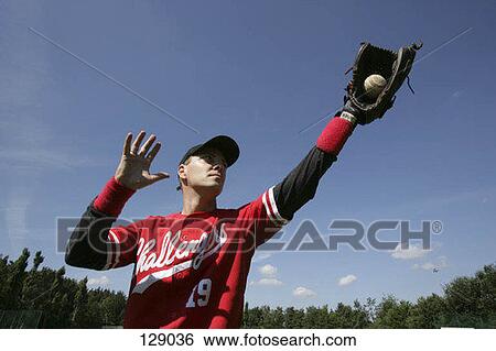 A baseball player catching a ball View Large Photo Image Stock Photograph - A baseball player catching a ball. Fotosearch