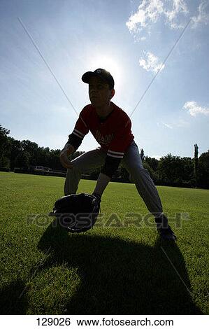Stock Photograph - A baseball player in the outfield. Fotosearch