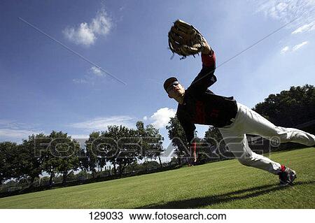 Stock Image - A baseball player leaning for a catch. Fotosearch