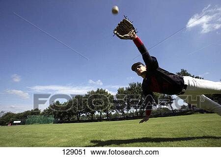 An outfielder leaping to catch a baseball View Large Photo Image Stock Image - An outfielder leaping to catch a baseball. Fotosearch