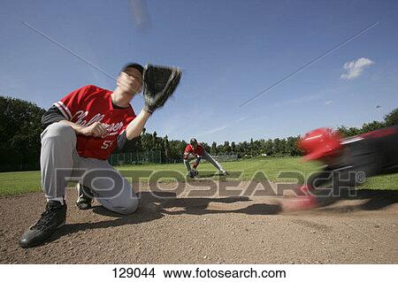 Picture - Baseball player sliding into a base. Fotosearch