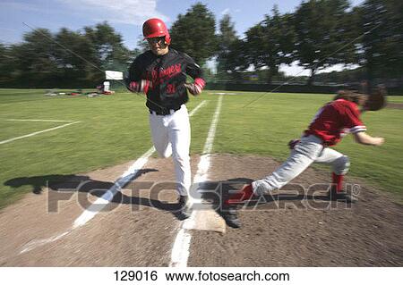 Stock Photograph - Baseball player stepping on a base. Fotosearch
