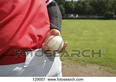 Stock Photo - Close-up of a baseball pitcher holding a baseball. Fotosearch