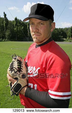 Portrait of baseball player holding a glove View Large Photo Image Stock Image - Portrait of baseball player holding a glove. Fotosearch