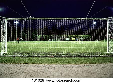 Players on a soccer field at night View Large Photo Image Stock Photo - Players on a soccer field at night. Fotosearch