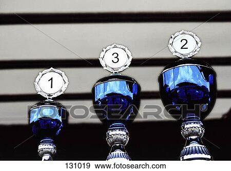 Three blue trophies in a row View Large Photo Image Stock Photo - Three blue trophies in a row. Fotosearch