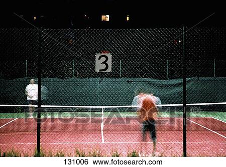 Stock Photograph - Two people playing tennis. Fotosearch