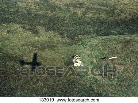 The shadow of a small airplane on a field View Large Photo Image Stock Photo - The shadow of a small airplane on a field. Fotosearch
